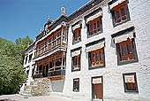 Ladakh - Sankar gompa (Leh), the main monastery halls with the characteristc red painted windows and woden balconies on white washed faades 